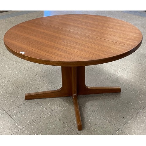 13 - A Danish teak circular extending dining table