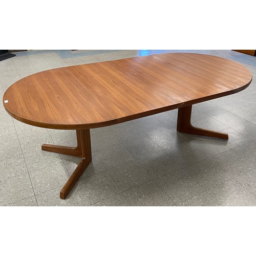 13 - A Danish teak circular extending dining table