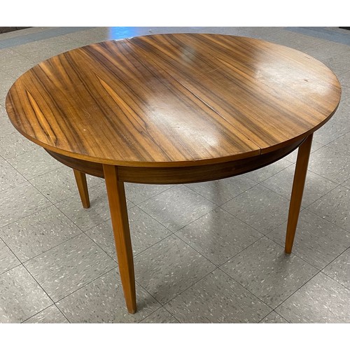 72 - A teak and afromosia circular extending dining table