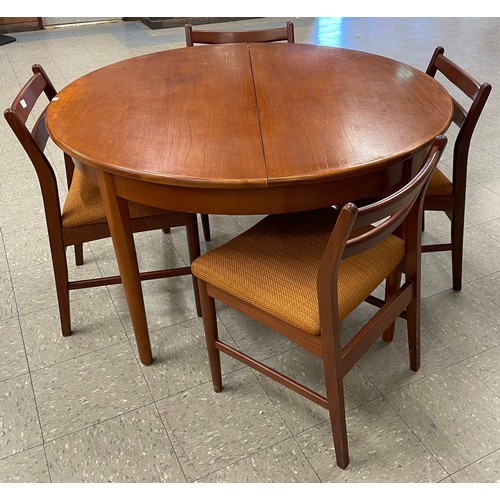 70 - A Jentique teak circular extending dining table and four chairs
