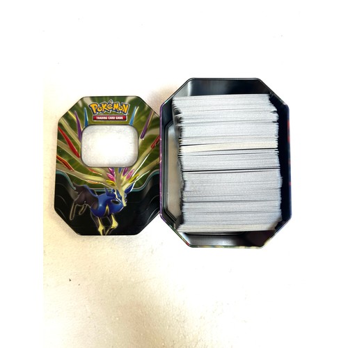 5006B - 3 Pokémon tins containing approximately 1100 Pokémon cards from various sets including Ascended Hero... 