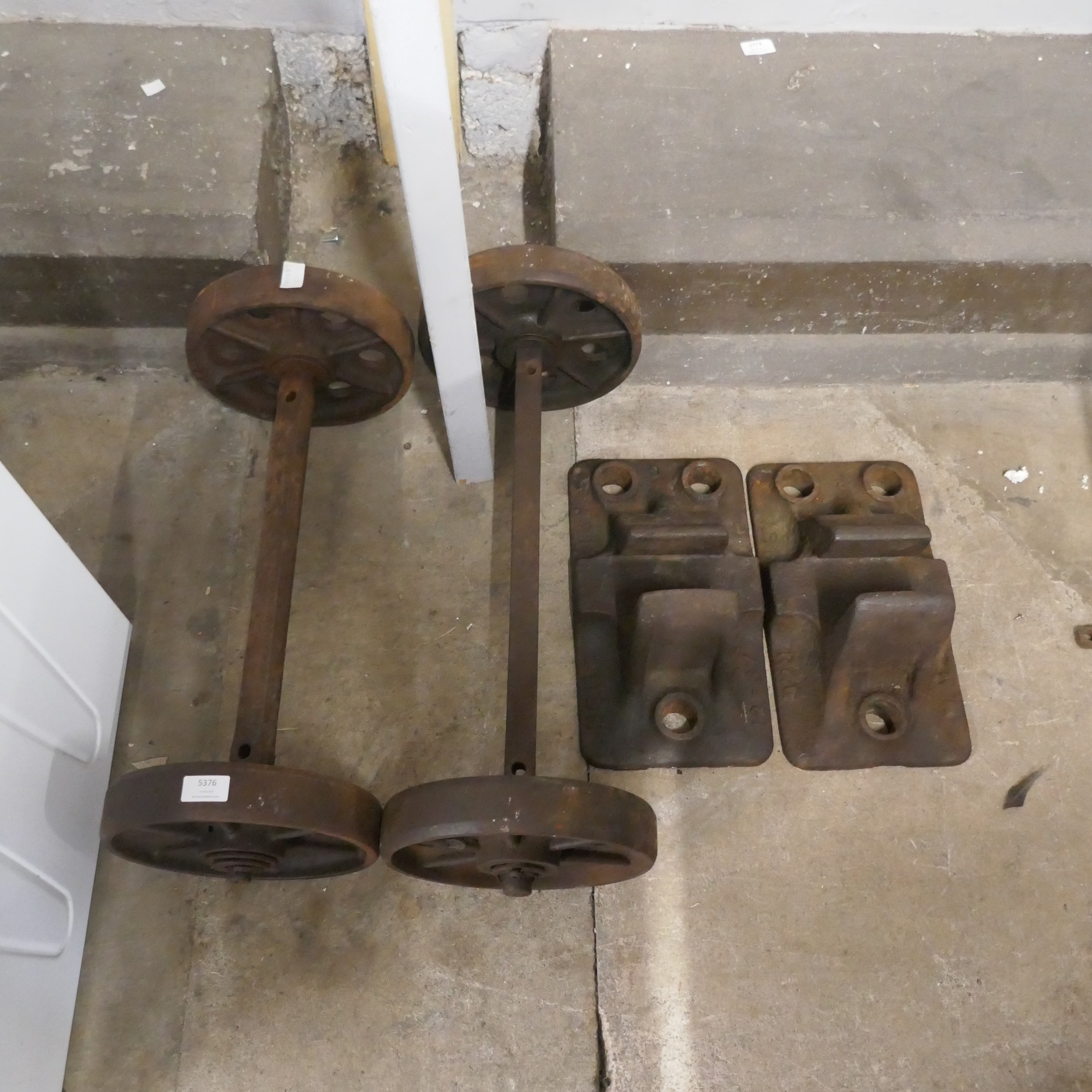 A pair of cast iron rail chain and 2 porters sack truck wheels