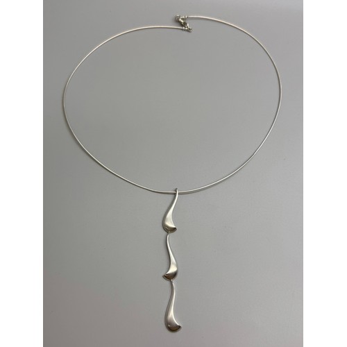 7252 - Paul Spurgeon, a white metal Modernist style abstract design necklace pendant, tests as silver, on a... 