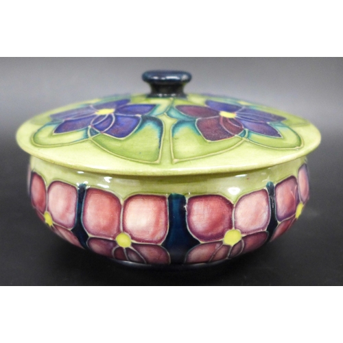 2050 - A Moorcroft Pottery violet pattern lidded pot