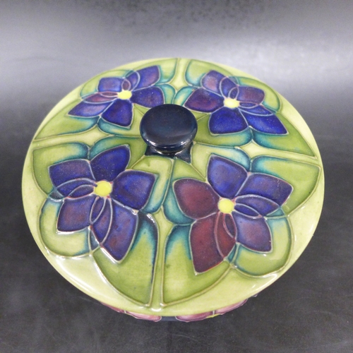 2050 - A Moorcroft Pottery violet pattern lidded pot