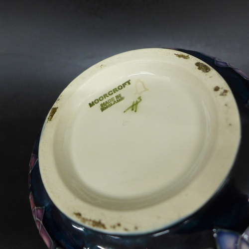 2050 - A Moorcroft Pottery violet pattern lidded pot