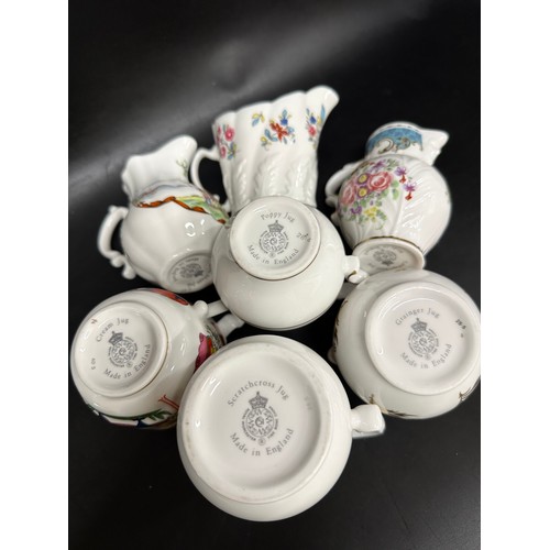 2262 - A collection of twelve Royal Worcester porcelain miniature jugs, various patterns