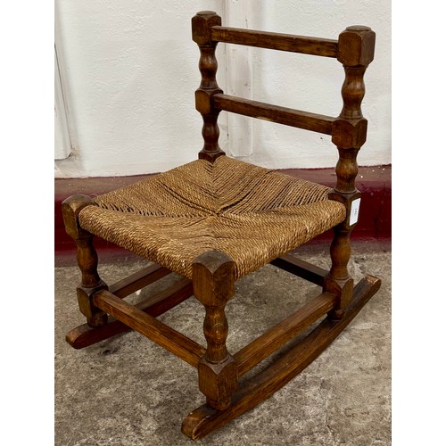 146 - A oak and paper cord seated child's rocking chair