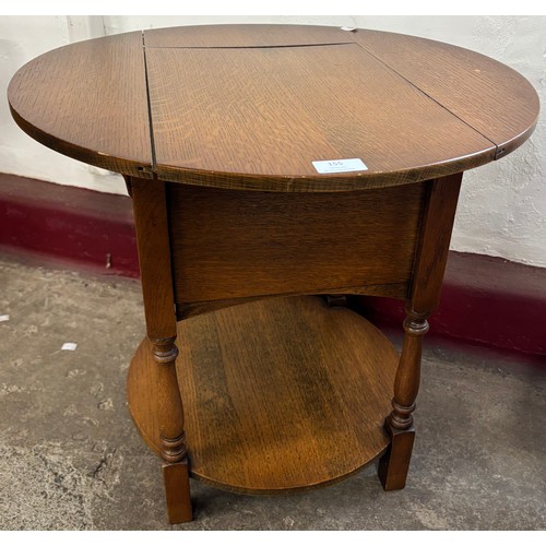 155 - An early 20th Century circular oak sewing table