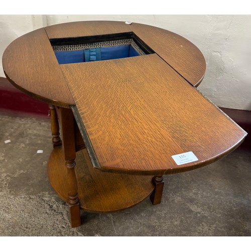 155 - An early 20th Century circular oak sewing table
