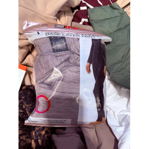 6136 - A pallet of mixed clothing to include trousers, shirts, underwear, coats, etc. various brands and si... 