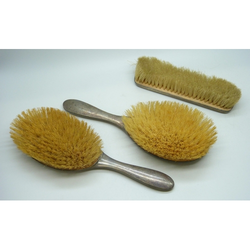 7023 - A set of three George V silver backed brushes, Birmingham, 1925, 370g total weight