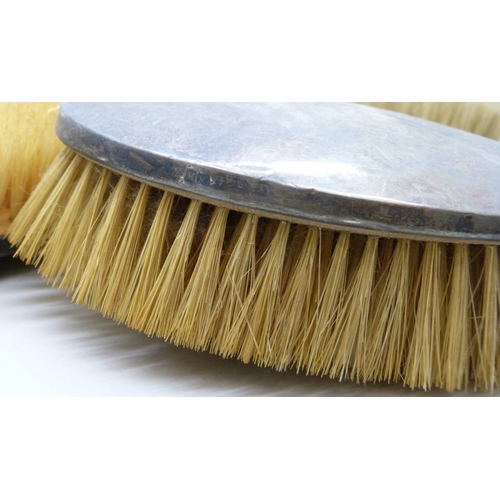 7023 - A set of three George V silver backed brushes, Birmingham, 1925, 370g total weight