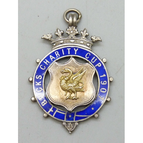 7027 - A silver matchbox case, a/f, a silver napkin ring, and a silver and enamel fob, 1907, cased, 23g tot... 