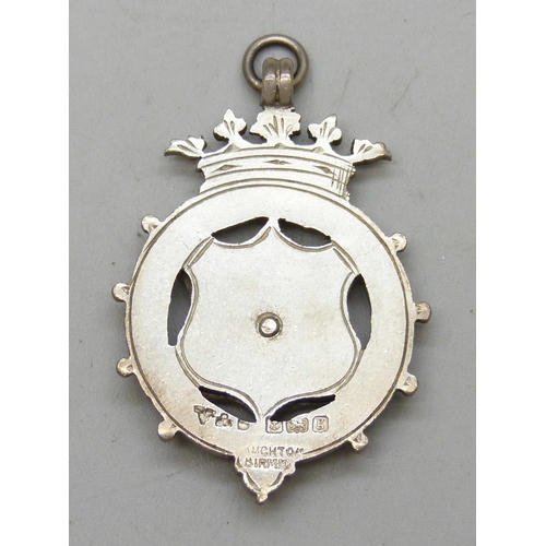 7027 - A silver matchbox case, a/f, a silver napkin ring, and a silver and enamel fob, 1907, cased, 23g tot... 
