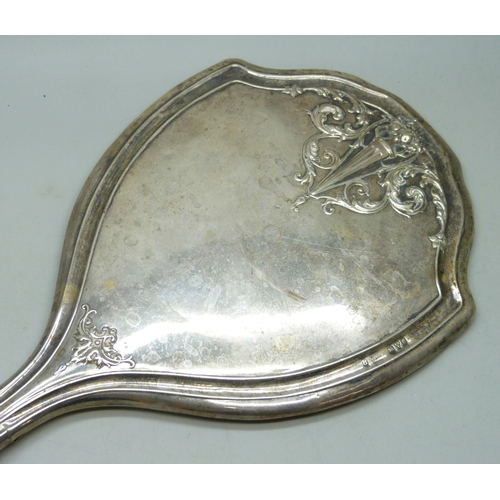 7032 - Three silver dressing table items - a hand mirror (a/f split), hair brush and clothes brush, 510g to... 