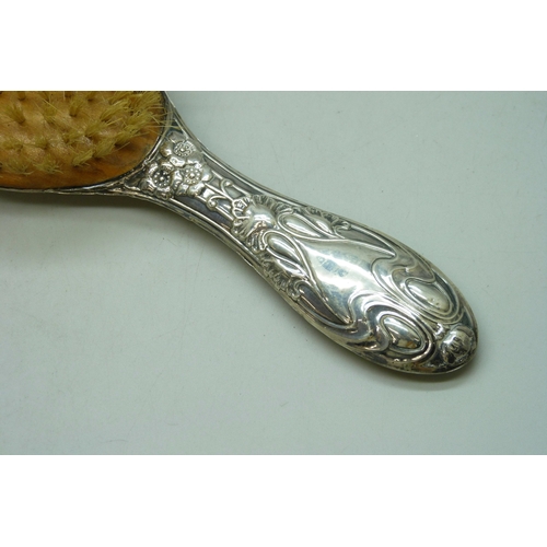 7032 - Three silver dressing table items - a hand mirror (a/f split), hair brush and clothes brush, 510g to... 