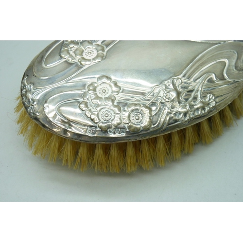 7032 - Three silver dressing table items - a hand mirror (a/f split), hair brush and clothes brush, 510g to... 
