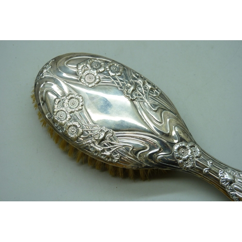 7032 - Three silver dressing table items - a hand mirror (a/f split), hair brush and clothes brush, 510g to... 