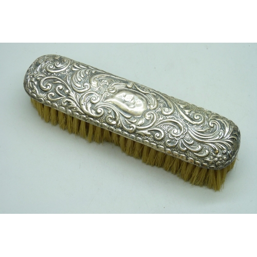 7032 - Three silver dressing table items - a hand mirror (a/f split), hair brush and clothes brush, 510g to... 