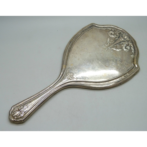7032 - Three silver dressing table items - a hand mirror (a/f split), hair brush and clothes brush, 510g to... 