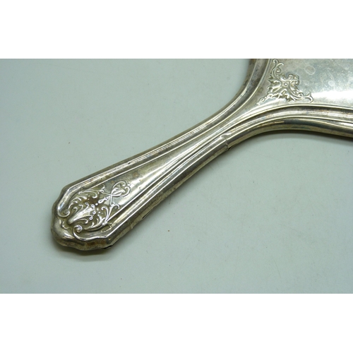 7032 - Three silver dressing table items - a hand mirror (a/f split), hair brush and clothes brush, 510g to... 