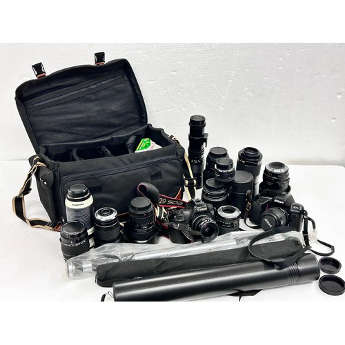 2294 - A large quantity of lenses and a Canon camera body, together with stands