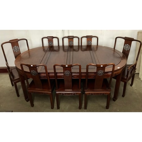 119A - A circular Chinese hardwood extending dining table and eight chairs