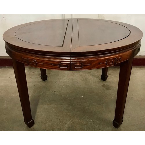 119A - A circular Chinese hardwood extending dining table and eight chairs
