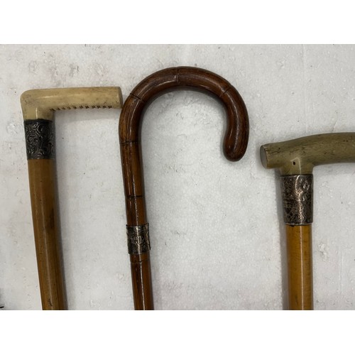 2273 - Three silver top walking sticks and umbrella
