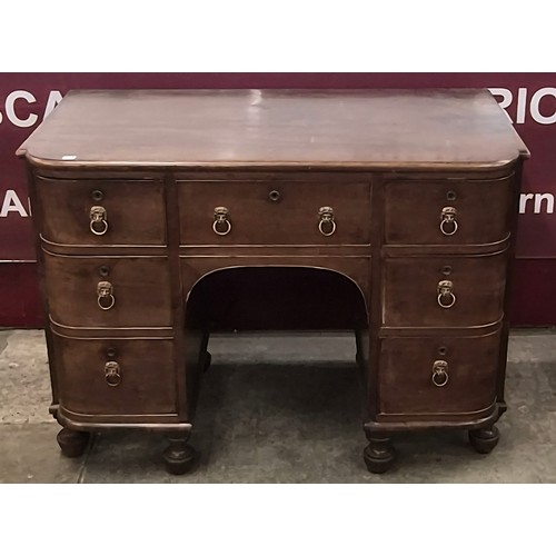 76 - A George IV mahogany breakfront kneehole desk