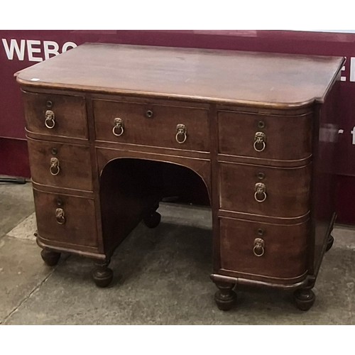 76 - A George IV mahogany breakfront kneehole desk
