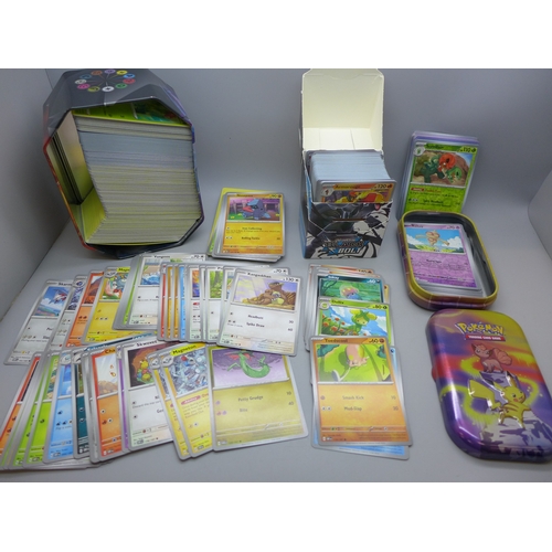 2228 - A large collection of Pokémon cards in collectors tin containing over 630 cards including a quantity... 
