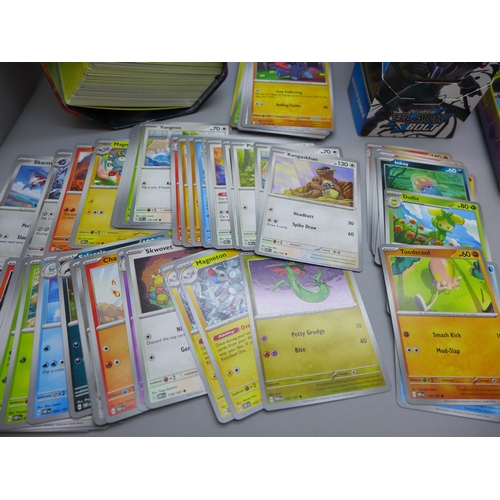 2228 - A large collection of Pokémon cards in collectors tin containing over 630 cards including a quantity... 