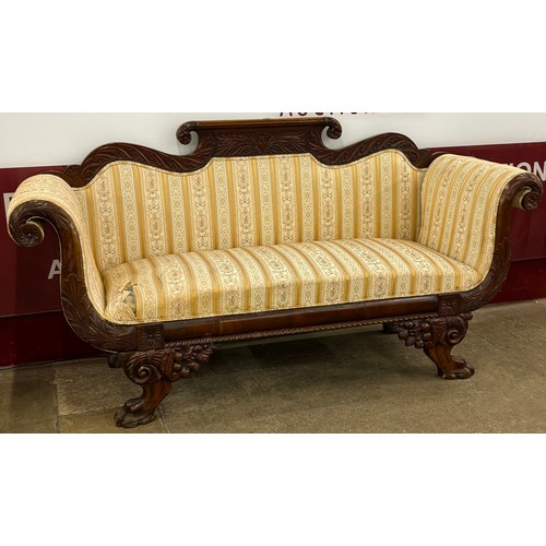 91 - A Regency carved mahogany and fabric upholstered scroll arm settee