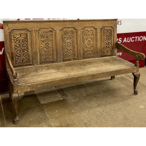 98 - A George III carved oak settle