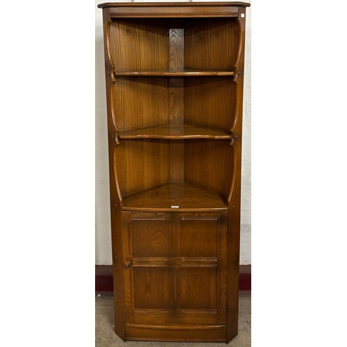 70 - An Ercol Golden Dawn Old Colonial elm corner cabinet