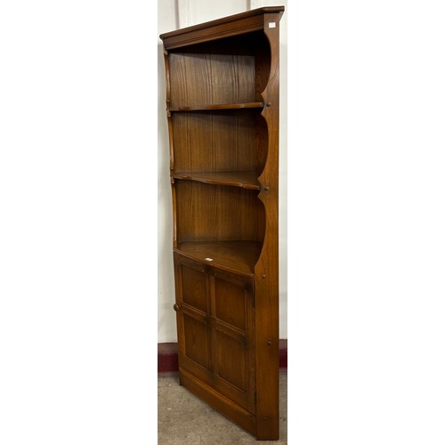 70 - An Ercol Golden Dawn Old Colonial elm corner cabinet