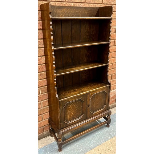 106 - An earyl 20th Century oak geometric moulded open bookcase