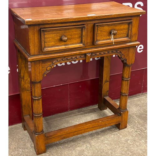 99 - An 18th Century style oak two drawer hall table