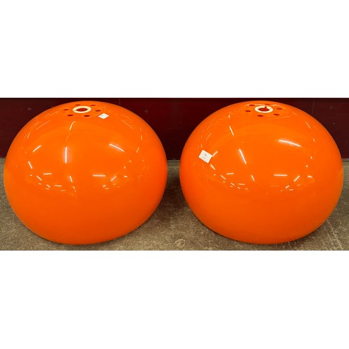 73 - A pair of mid 20th Century orange Perspex light shades