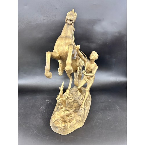 2284 - A spelter gilt painted figure of a horse with handler, approx. 40cm h