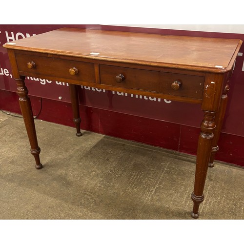 101 - A Victorian mahogany two drawer writing table