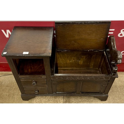 131 - An early 20th Century carved oak telephone seat