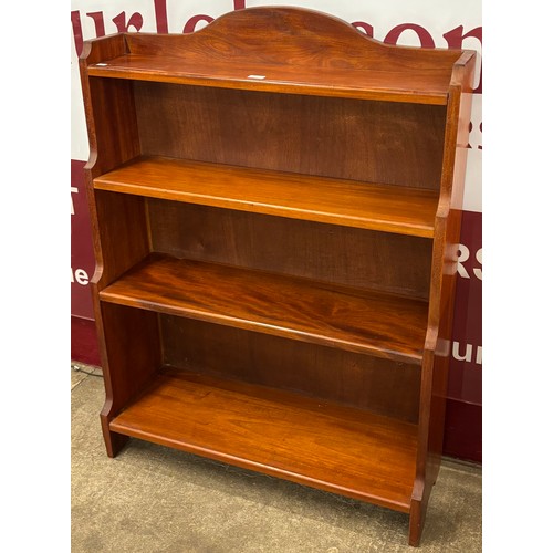 148 - A Regency style mahogany waterfall front open bookcase