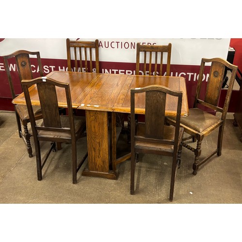 179 - An oak drop-leaf table and four chairs, with two other chairs