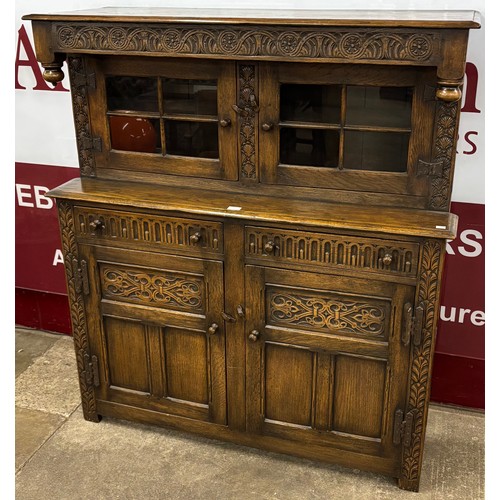 103 - An 18th Century style carved oak court cupboard
