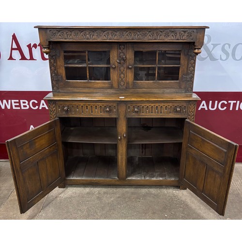 103 - An 18th Century style carved oak court cupboard