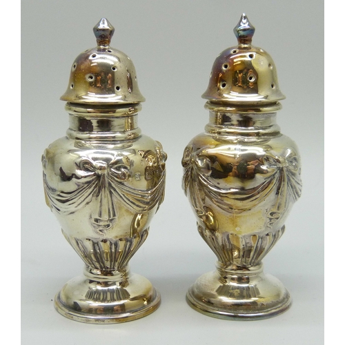 7130 - A Victorian silver salt and pepper with swag and bow design, Birmingham 1899 and 1900, 34g, 7.2cm, c... 