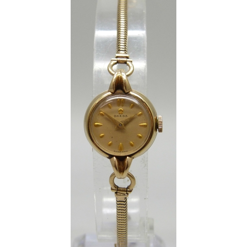 7148 - A lady's 9ct gold Omega wristwatch on a 9ct gold strap, 14.8g, 20mm including crown